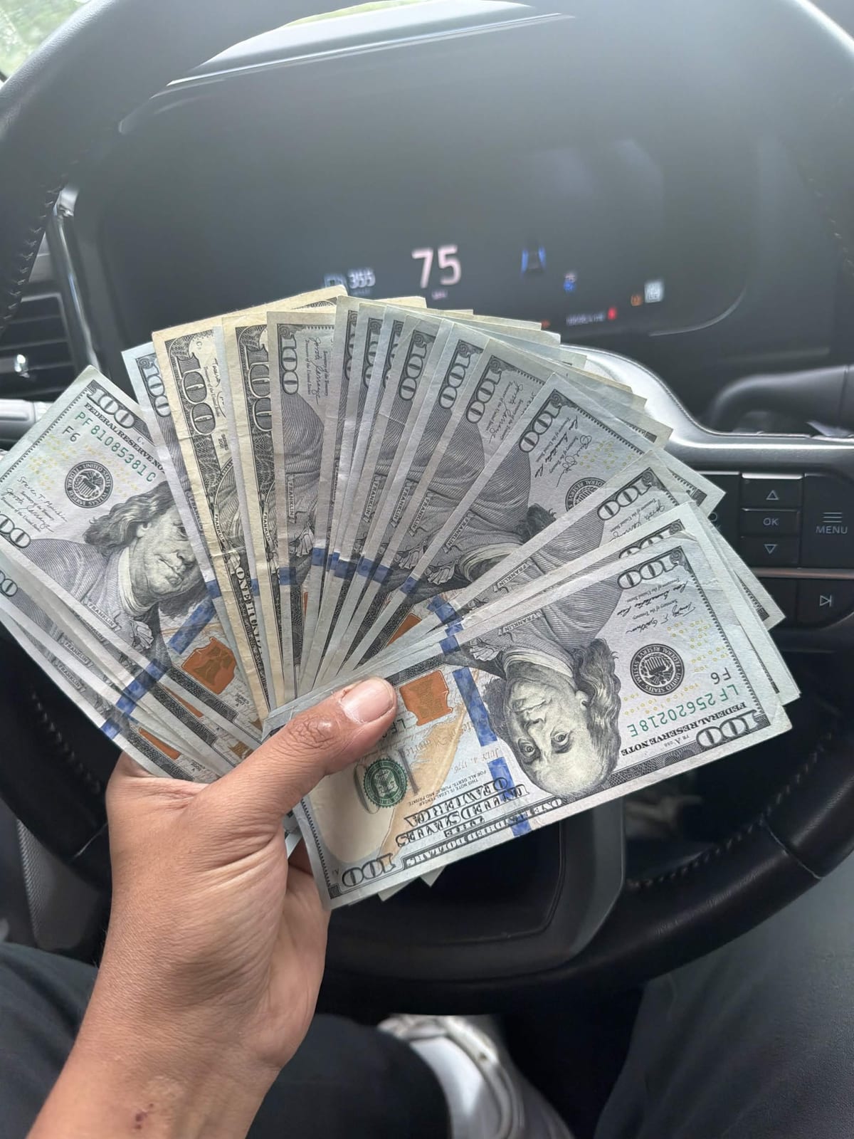 A fan of hundred-dollar bills, cash paid on the spot for a car in New England